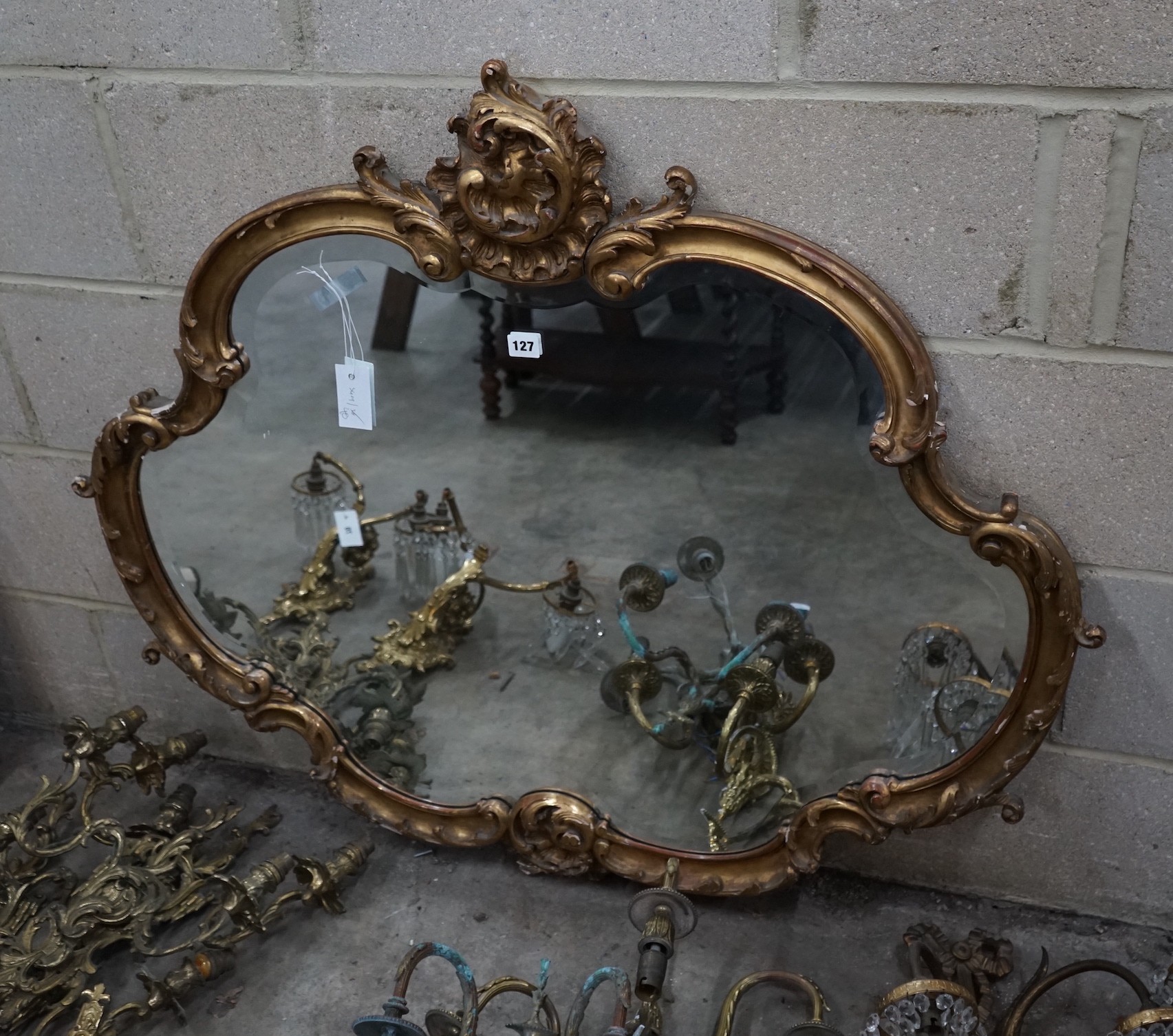 A Victorian carved giltwood shaped oval wall mirror, width 110cm, height 96cm